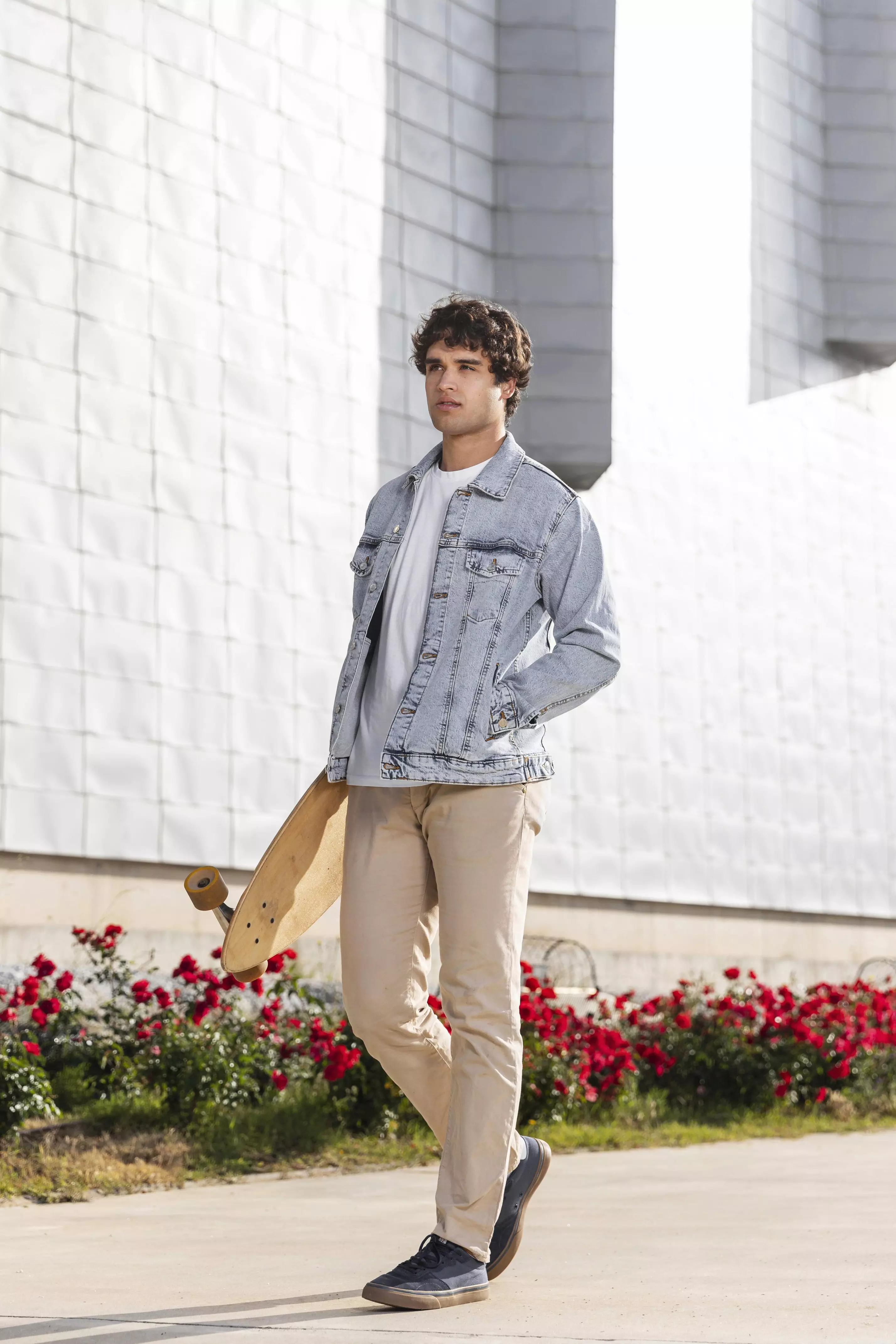 man-holding-skateboard-outdoors-min